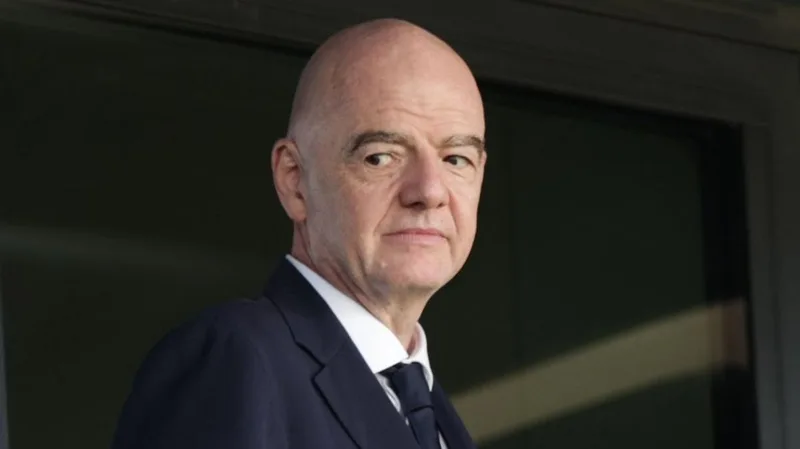 Head and shoulders view of Gianni Infantino looking to his right, as he wears dark jacket and tie and a white shirt (photo: BBC)
