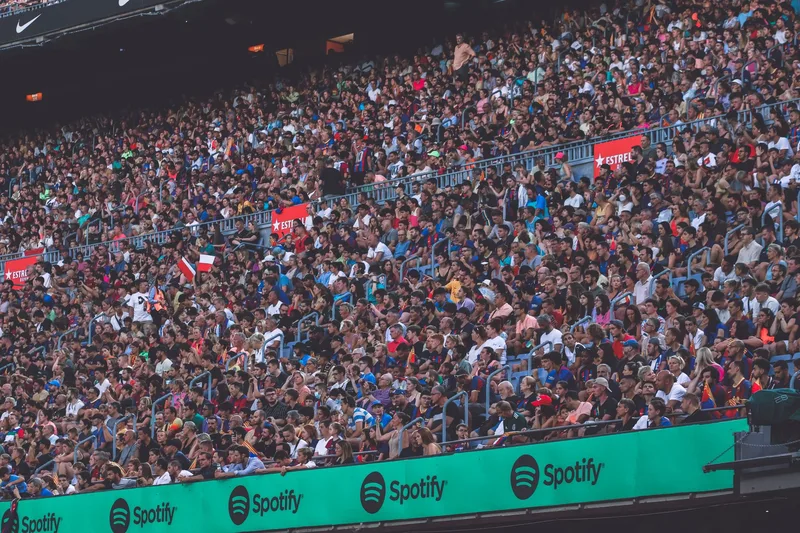 A packed stadium with enthusiastic fans cheering, showcasing diverse spectators. (stock photo via Pexels)